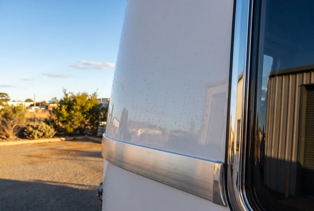 Close-up of glossy detailed caravan panel with beaded water in O'Connor caravan detailing