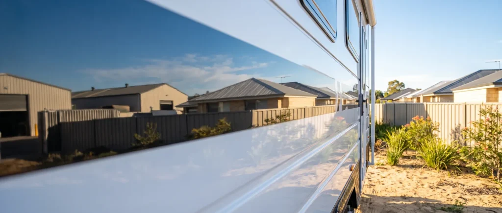 Mirror-glossy cut and polish finish on a caravan side panel from Nomad Caravan Detailing in O'Connor