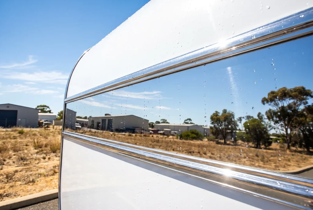 Close-up of glossy freshly detailed caravan exterior panel by Nomad Caravan Detailing in O'Connor WA